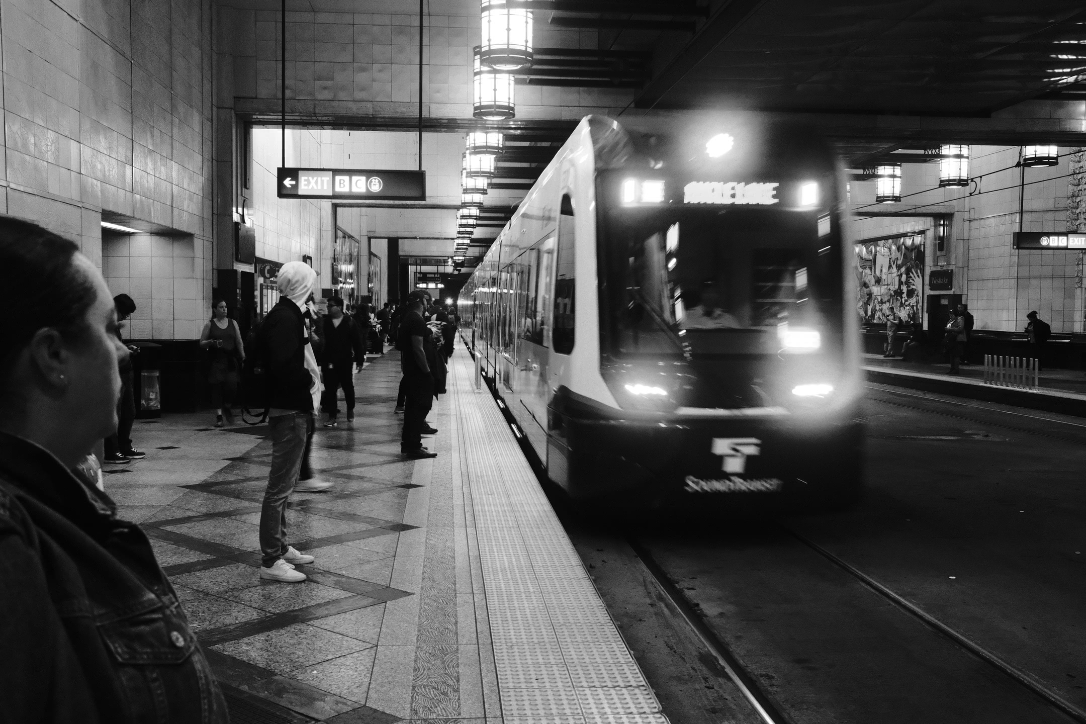 Light rail train arriving at a station platform.