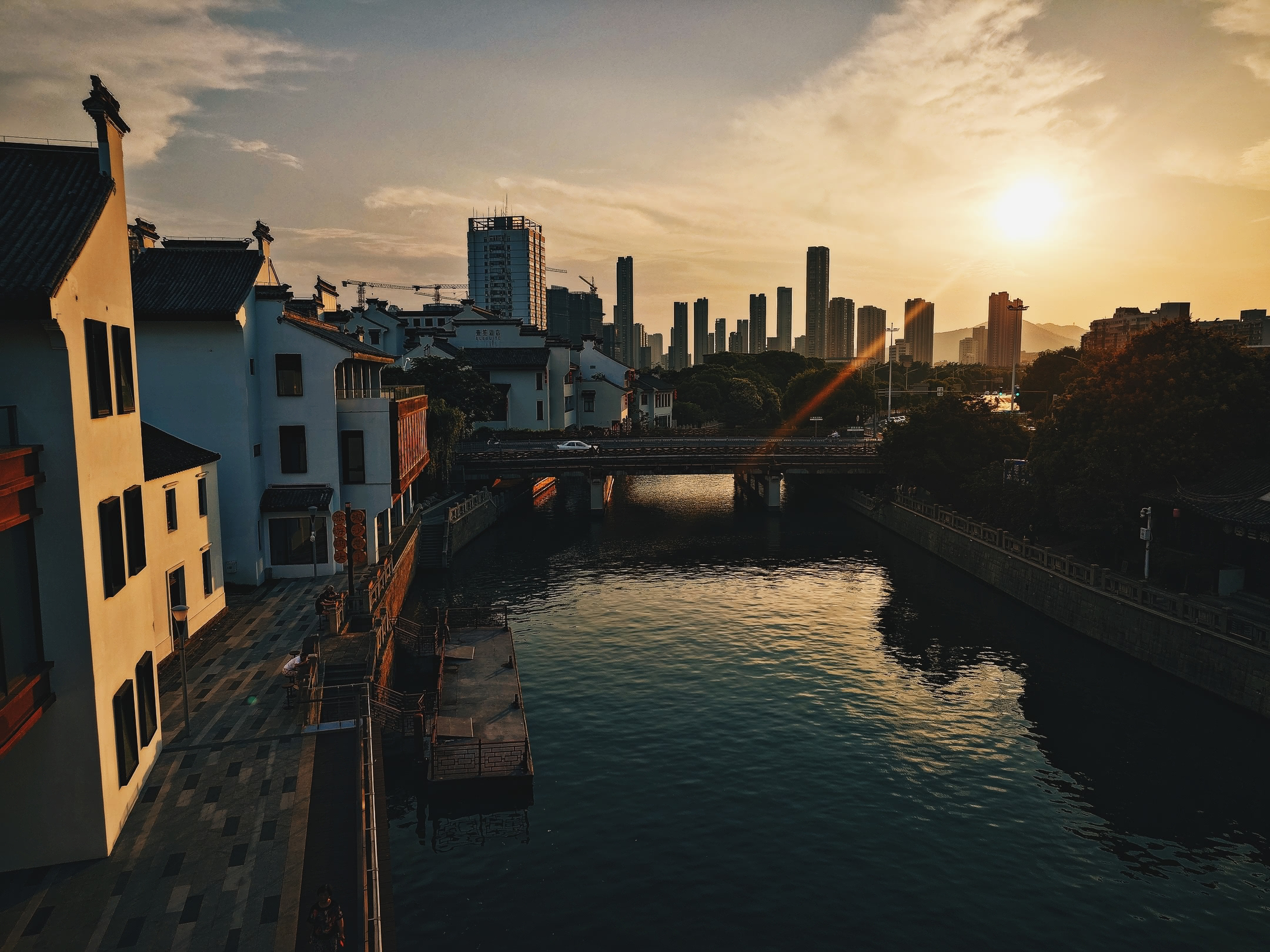 Canal at late afternoon with city buildings in background. From patio of Red Lion bar.