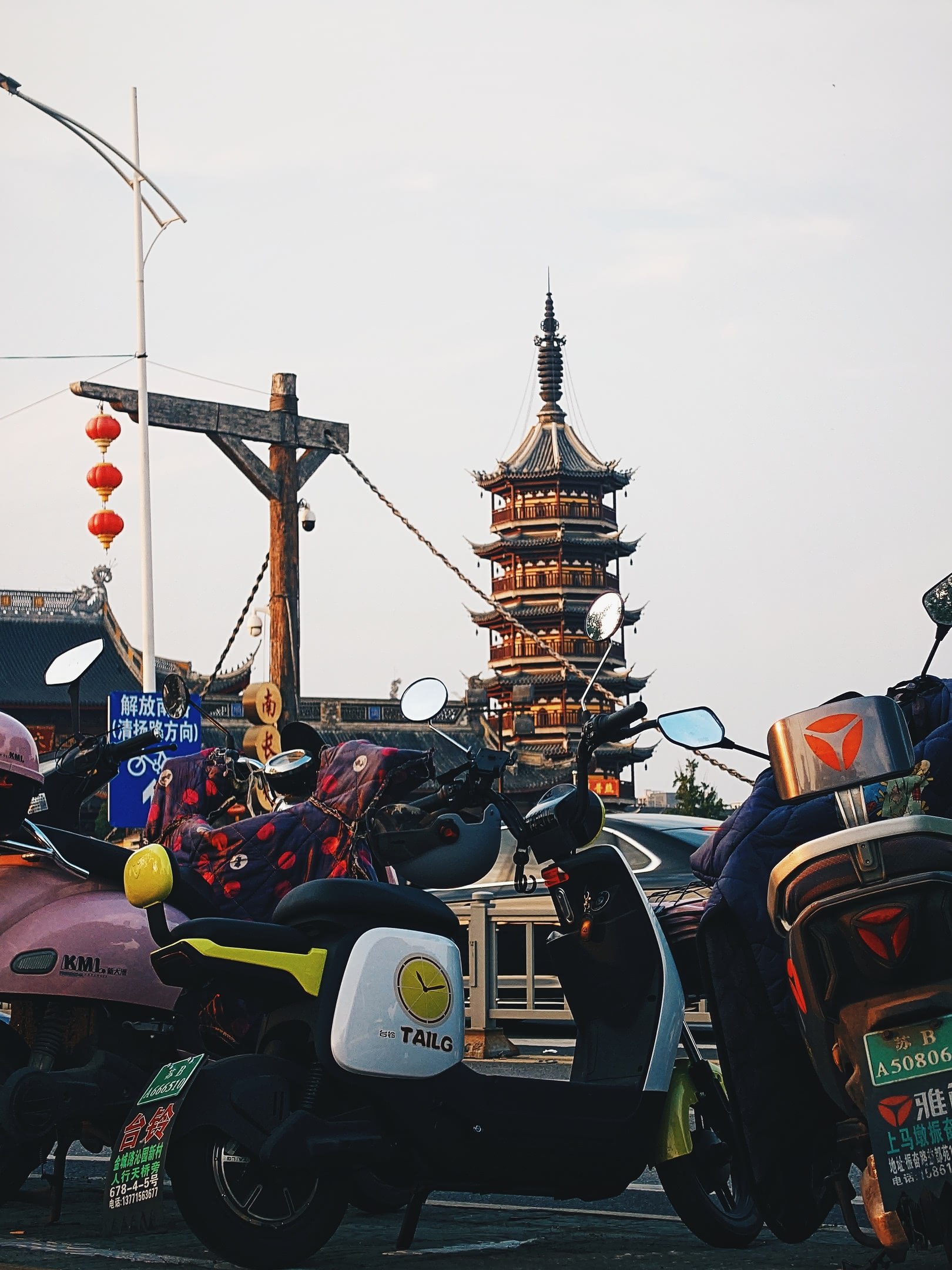 Wúxī Nánchán Temple pagoda behind parked e-bikes.