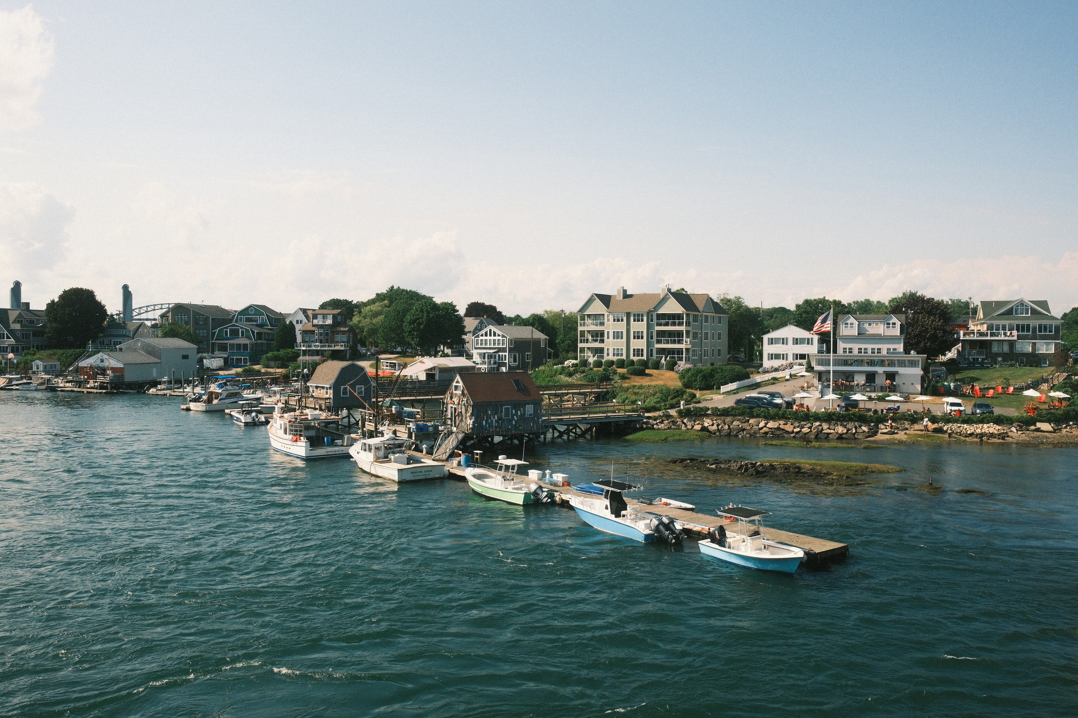 Dock area of Badgers Island with homes and yacht club in backgrond.